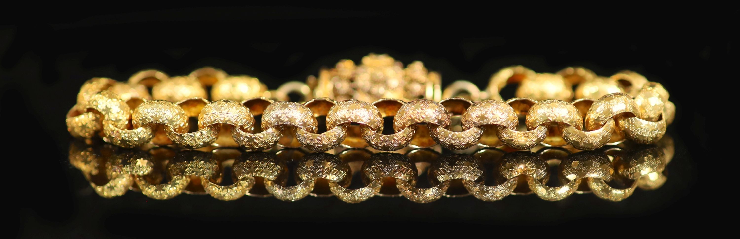A 19th century star engraved belcher link bracelet, with pierced cannettile work, barrel shaped clasp